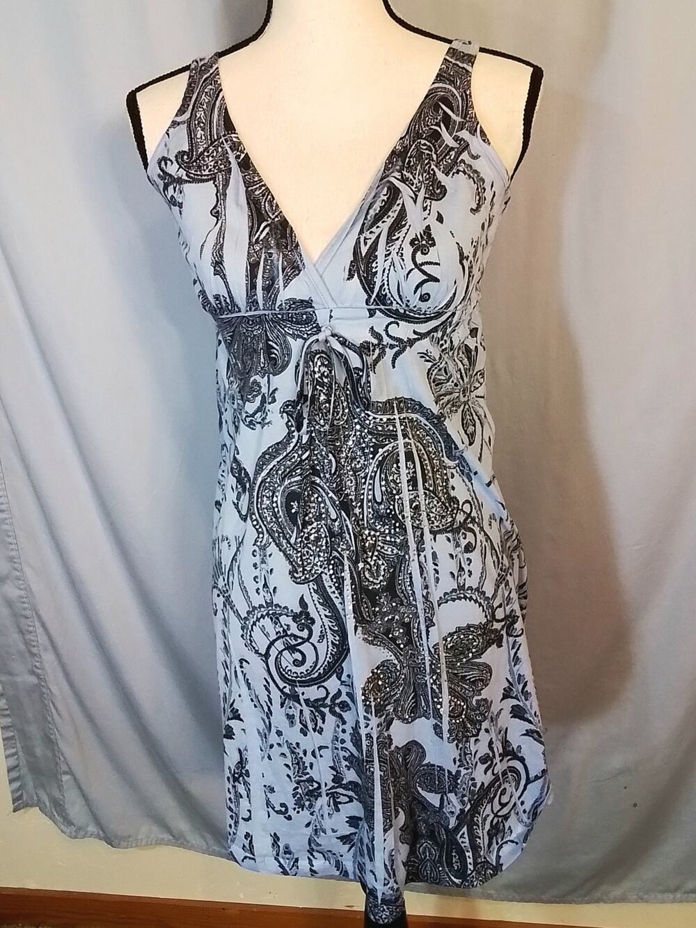 Press, Sleeveless blue dress with clear rhinestones.